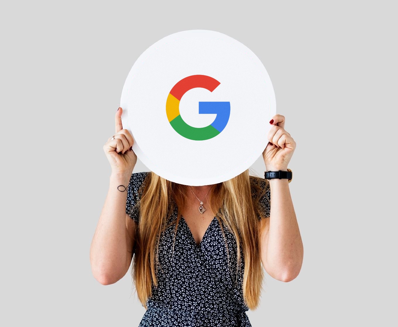 Person holding up a Google logo